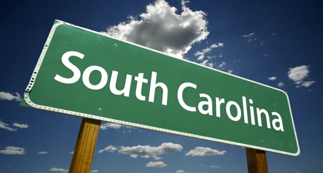 South Carolina road sign with blue sky and clouds in background